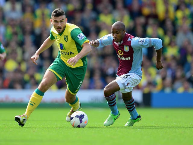 Fabian Delph of Aston Villa battles with Robert Snodgrass of Norwich