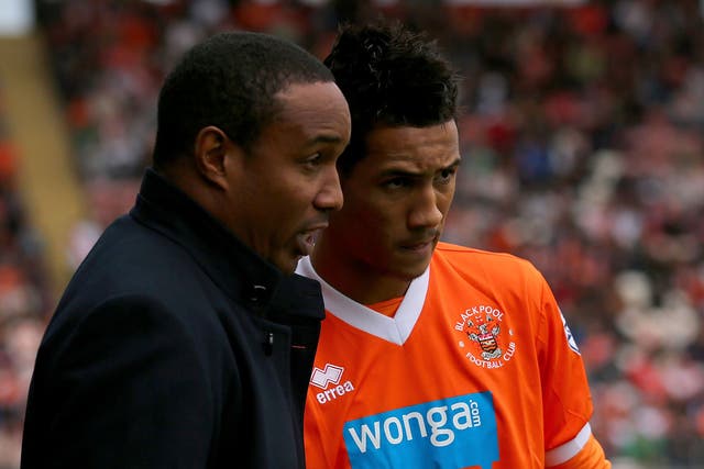 Family affair: Manager Paul Ince has a word with son Tom yesterday