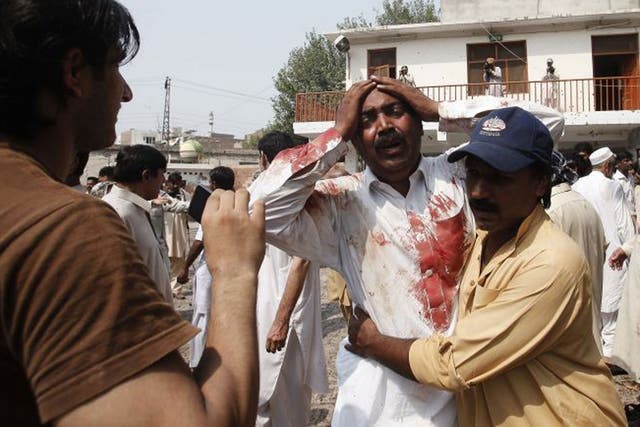 A man cries at the death of his brother at the blast site