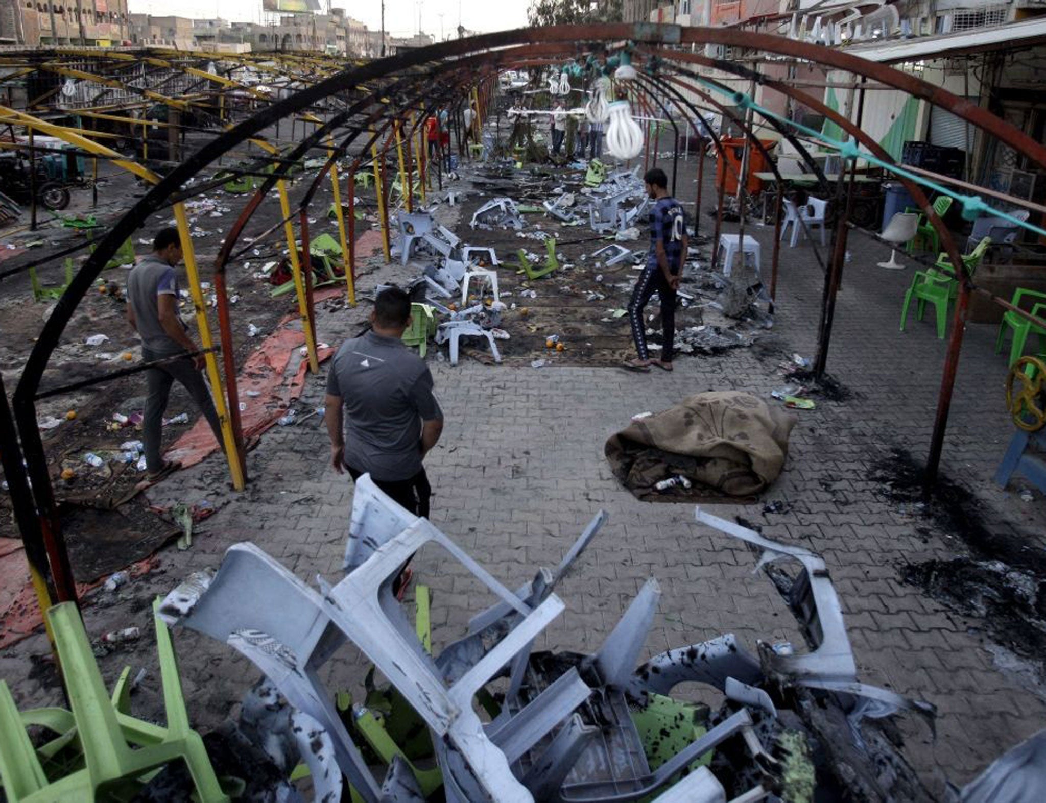 Survivors inspect the blast site