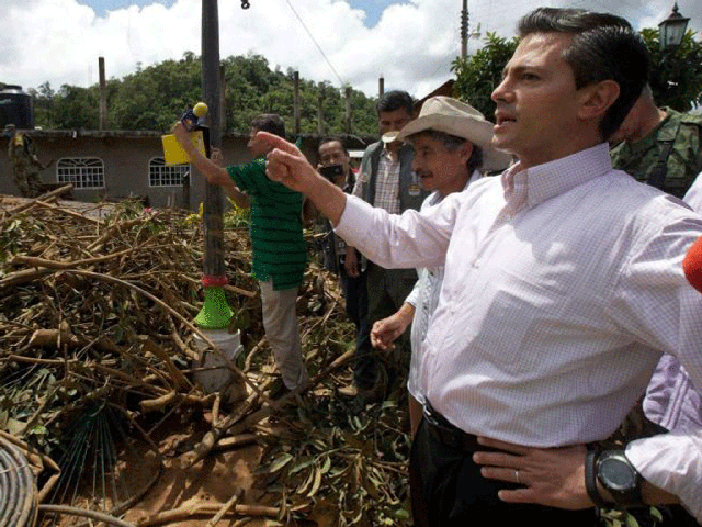 Mexico's President Enrique Pena Nieto (right) visiting storm-hit town of La Pintanda, told survivors of a heavy landslide that the 68 people missing as a result of the disaster are not likely to be found alive. 