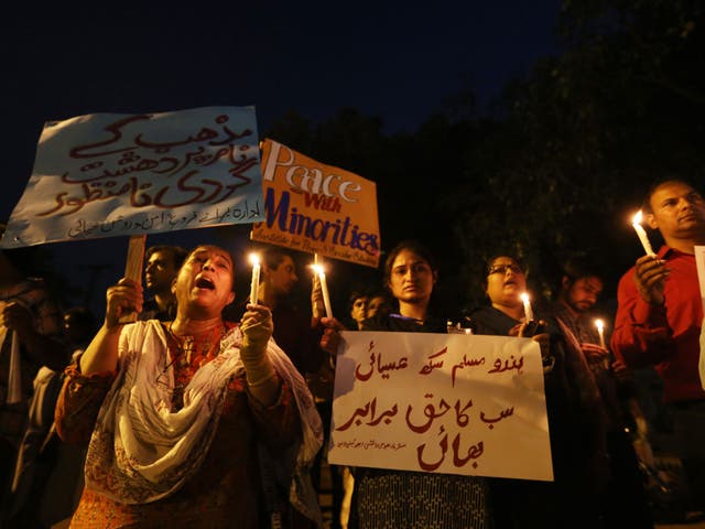 People light candles during a memorial ceremony for the Christian victims of twin suicide bombing that targeted a Christian Church in Peshawar, in Lahore, Pakistan