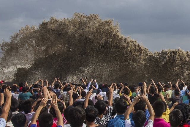 In Hangzhou, just south of Shanghai, the typhoon brought huge tidal waves on the Qiantang river