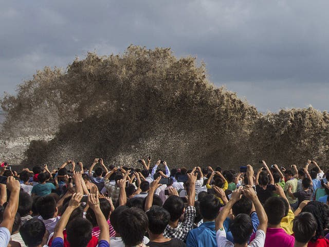 In Hangzhou, just south of Shanghai, the typhoon brought huge tidal waves on the Qiantang river