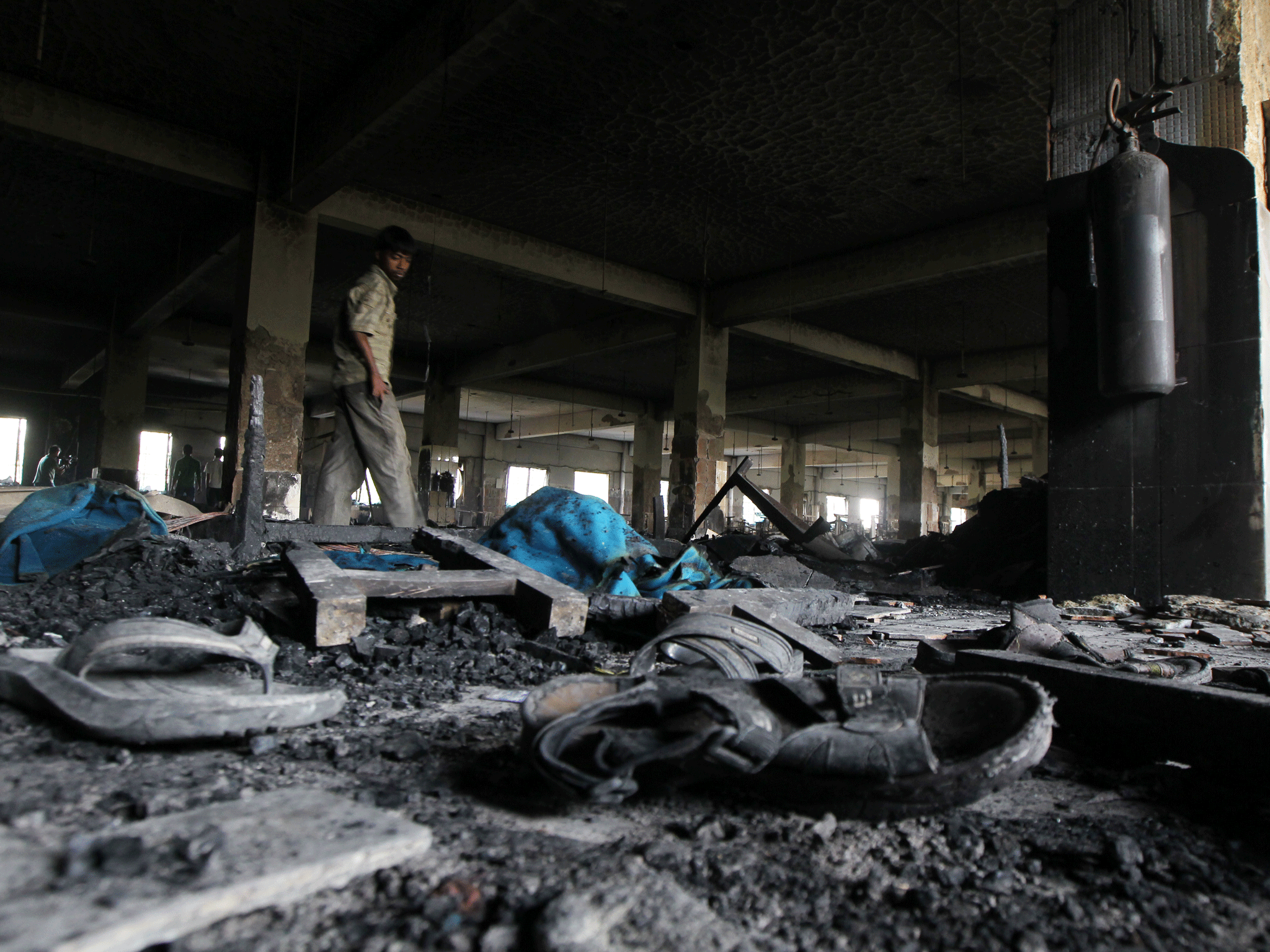 The charred remains of the Tazreen Fashion factory after a fire last November that killed 110 workers. It is claimed that factory managers had prevented employees from escaping the blaze.