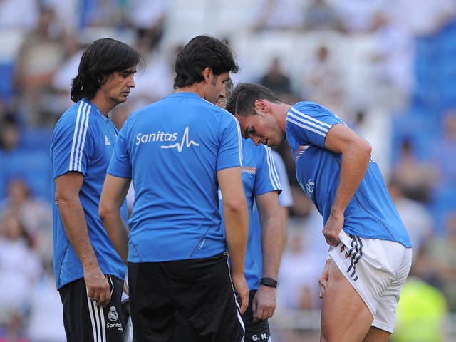 Gareth Bale assesses his injury at the Bernabeu