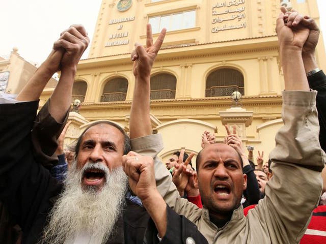 Pro-Muslim Brotherhood protestors shout slogans during a demonstration in front of the group's headquarters in Moqattam district, Cairo.