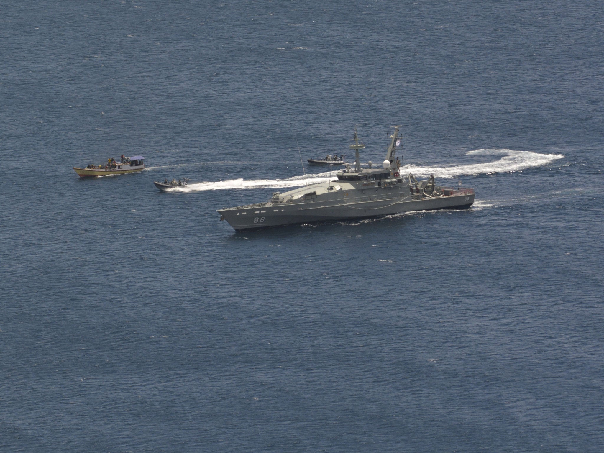 A suspected asylum seeker vessel is intercepted and escorted by the Australian Navy