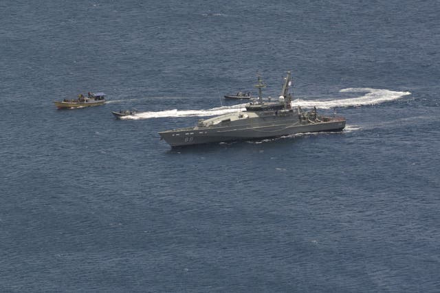 A suspected asylum seeker vessel is intercepted and escorted by the Australian Navy