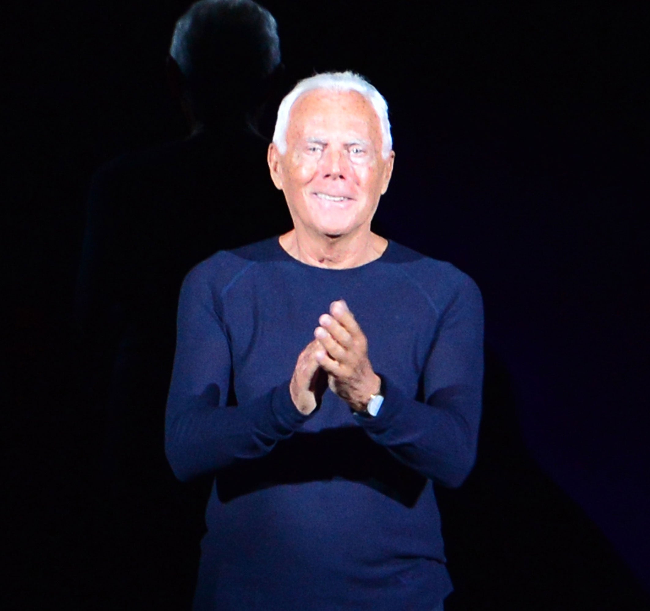 Giorgio Armani acknowledges the audience at the end of his show