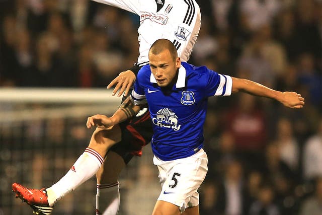 Dimitar Berbatov of Fulham rises above Everton’s John Heitinga