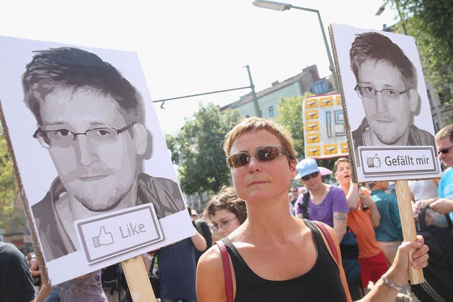 A German demonstrator protests in support of whistleblower and former NSA employee Edward Snowden during a protest in Berlin