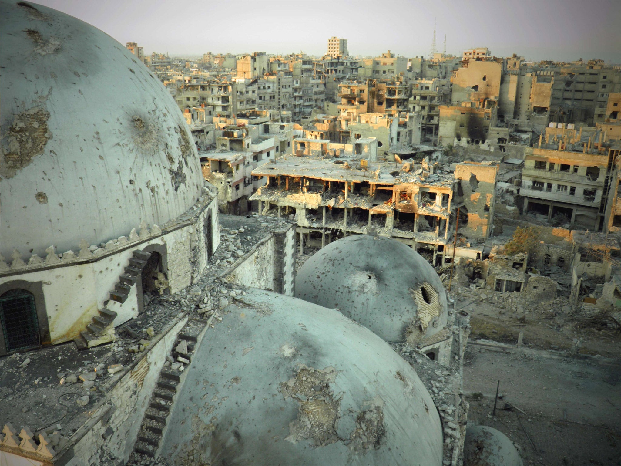 A view from the damaged Khaled bin Walid mosque in the al-Khalidiyah neighbourhood of Homs (Getty)