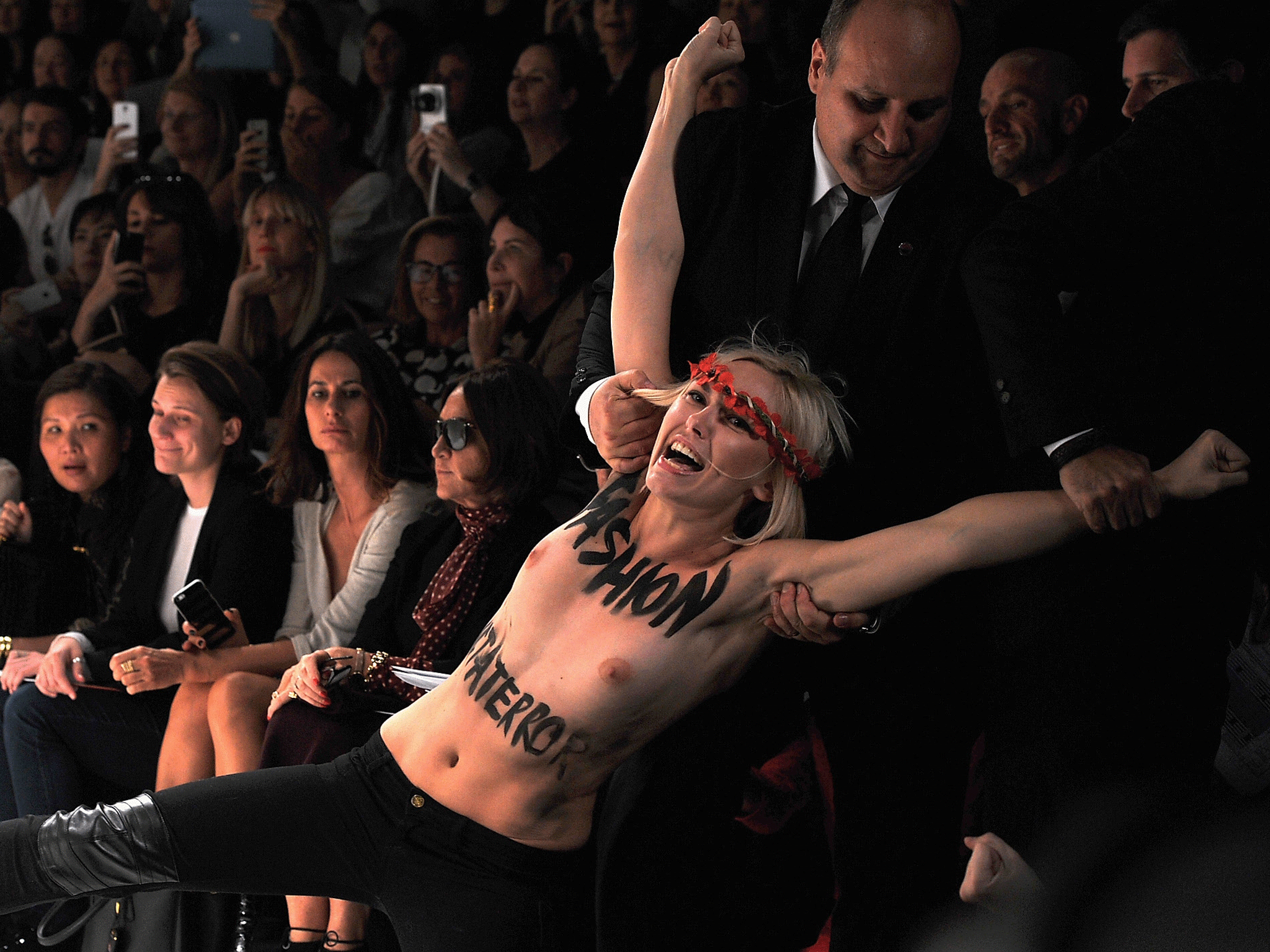 PARIS, FRANCE - SEPTEMBER 26: Femen activist disturbs the Nina Ricci show as part of the Paris Fashion Week Womenswear Spring/Summer 2014. GETTY IMAGES