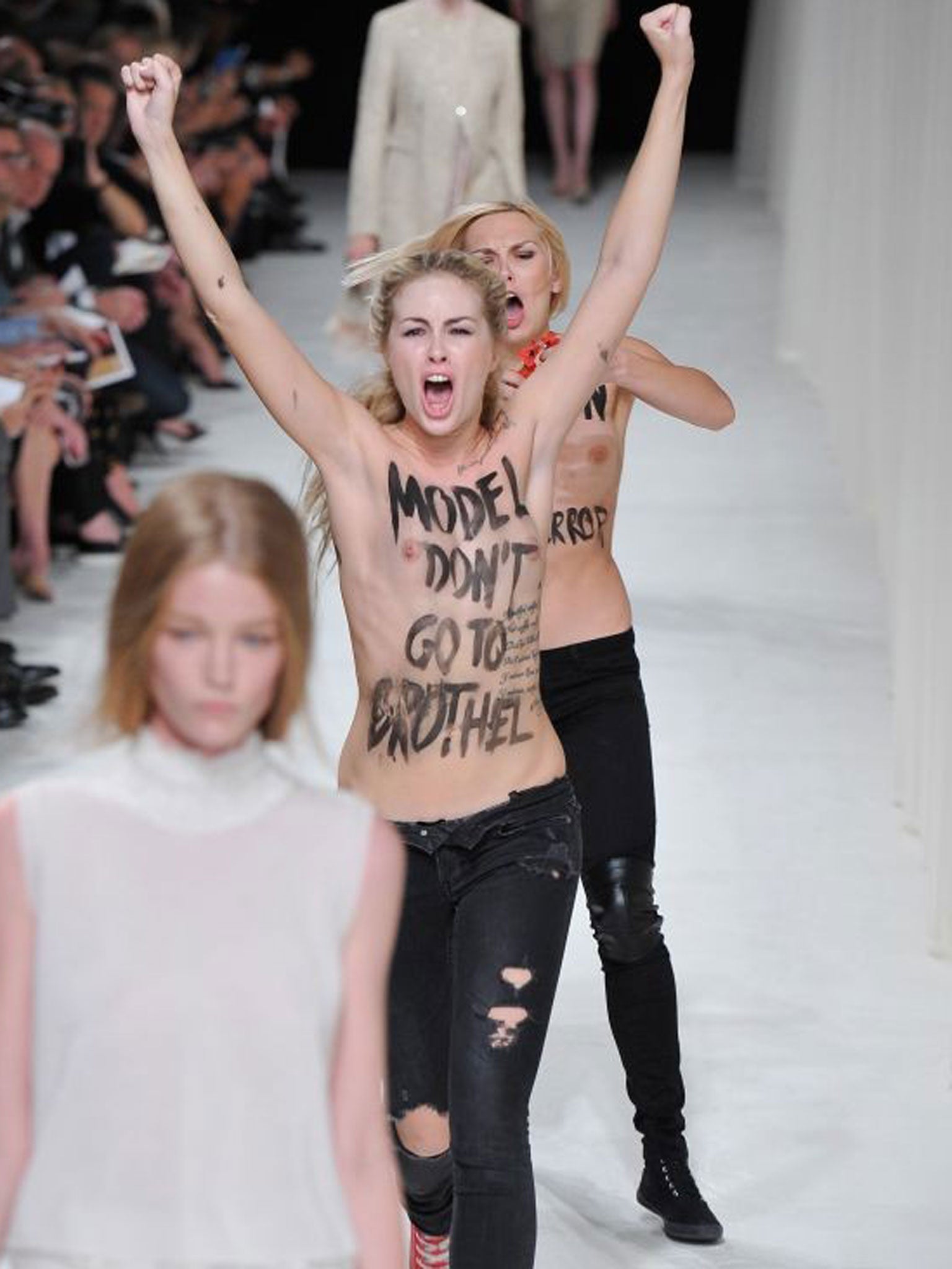ctivists of the Ukranian feminist protest group Femen disturb the Nina Ricci during Paris Fashion Week Womenswear Spring/Summer 2014 on 26 September