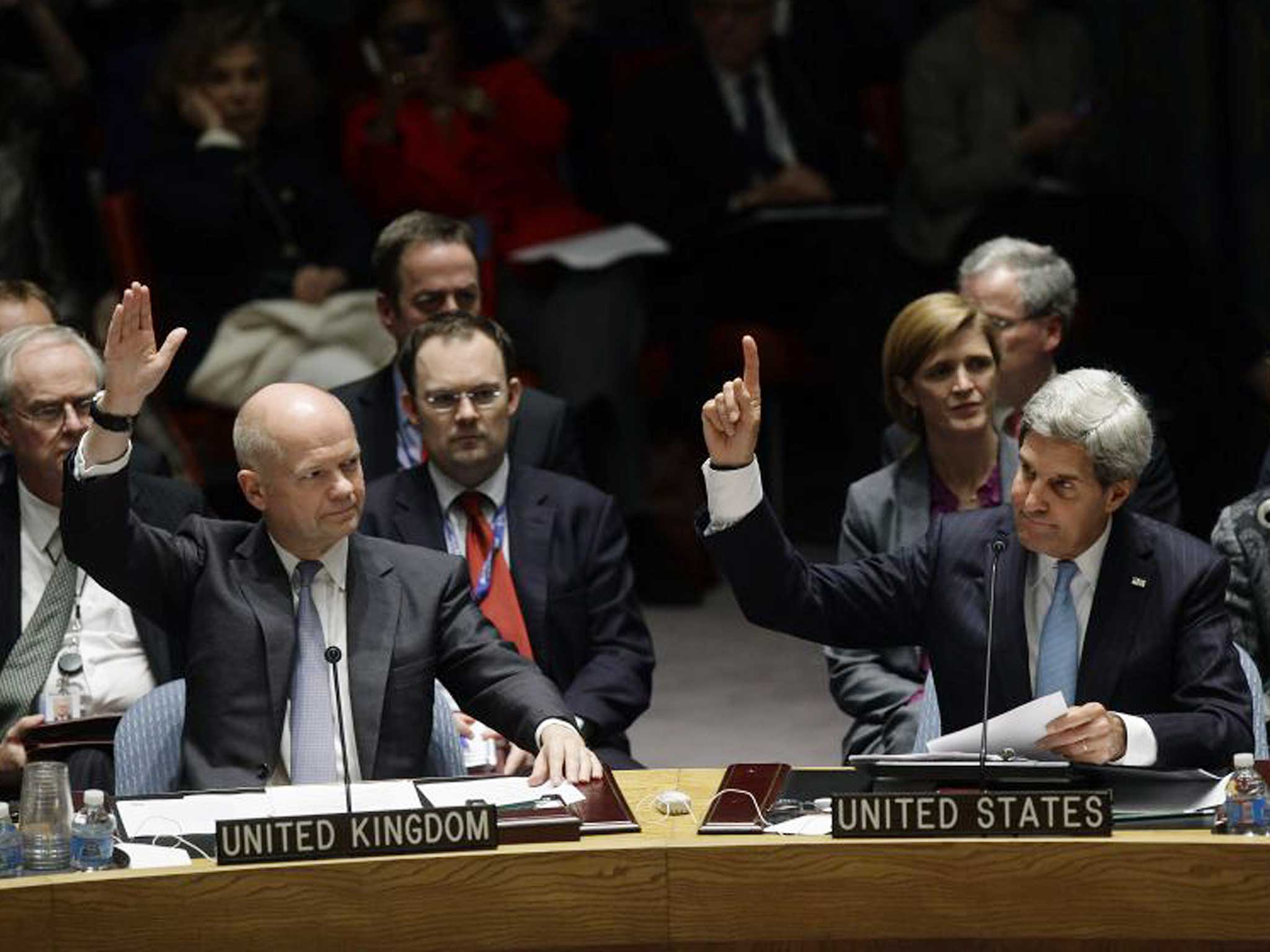 William Hague and John Kerry vote on a resolution regarding Syria's chemical weapons program at a meeting of the United Nations Security Council