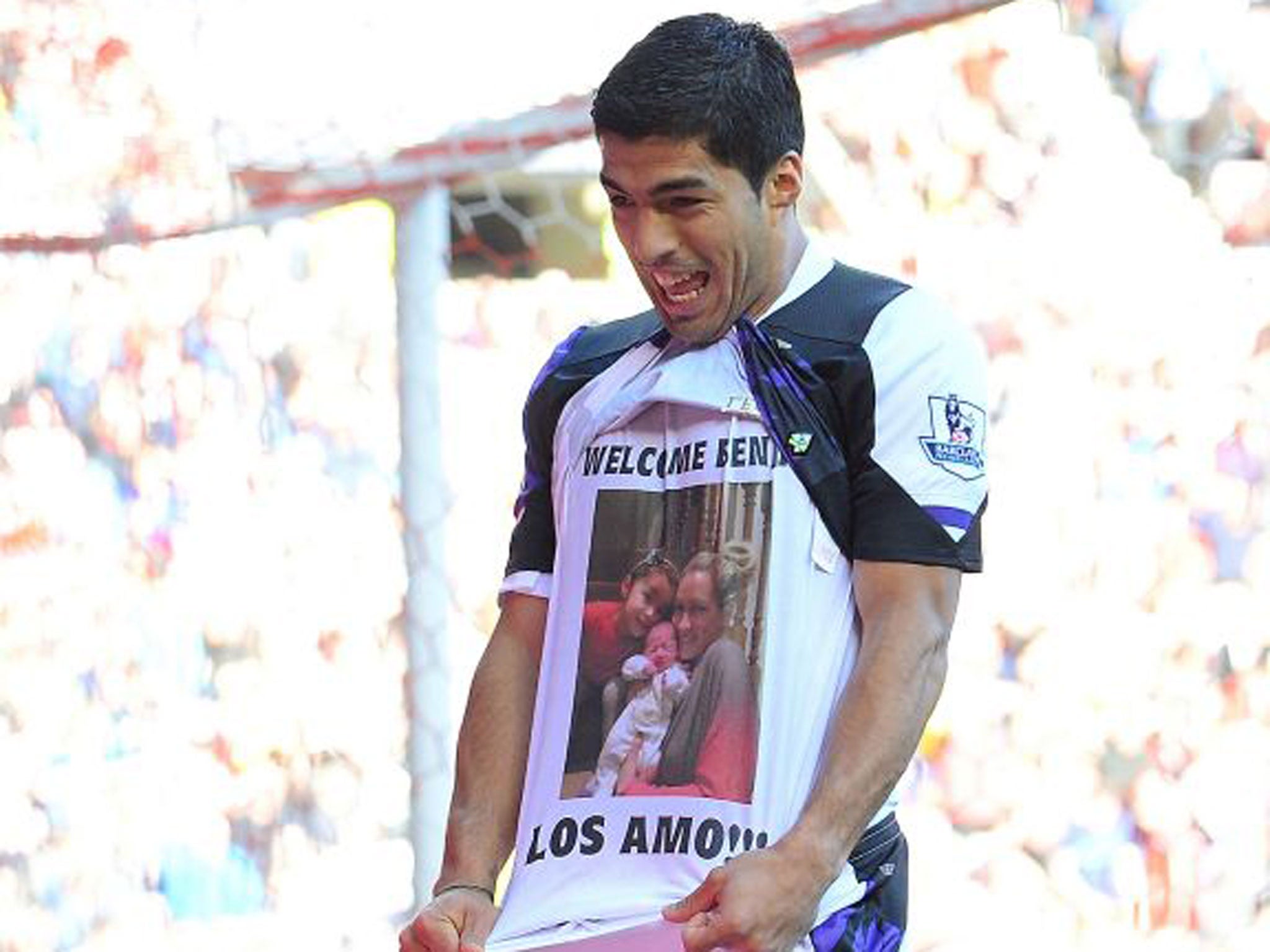 Luis Suarez celebrates his first goal of the match with a t-shirt in dedication to his new-born child
