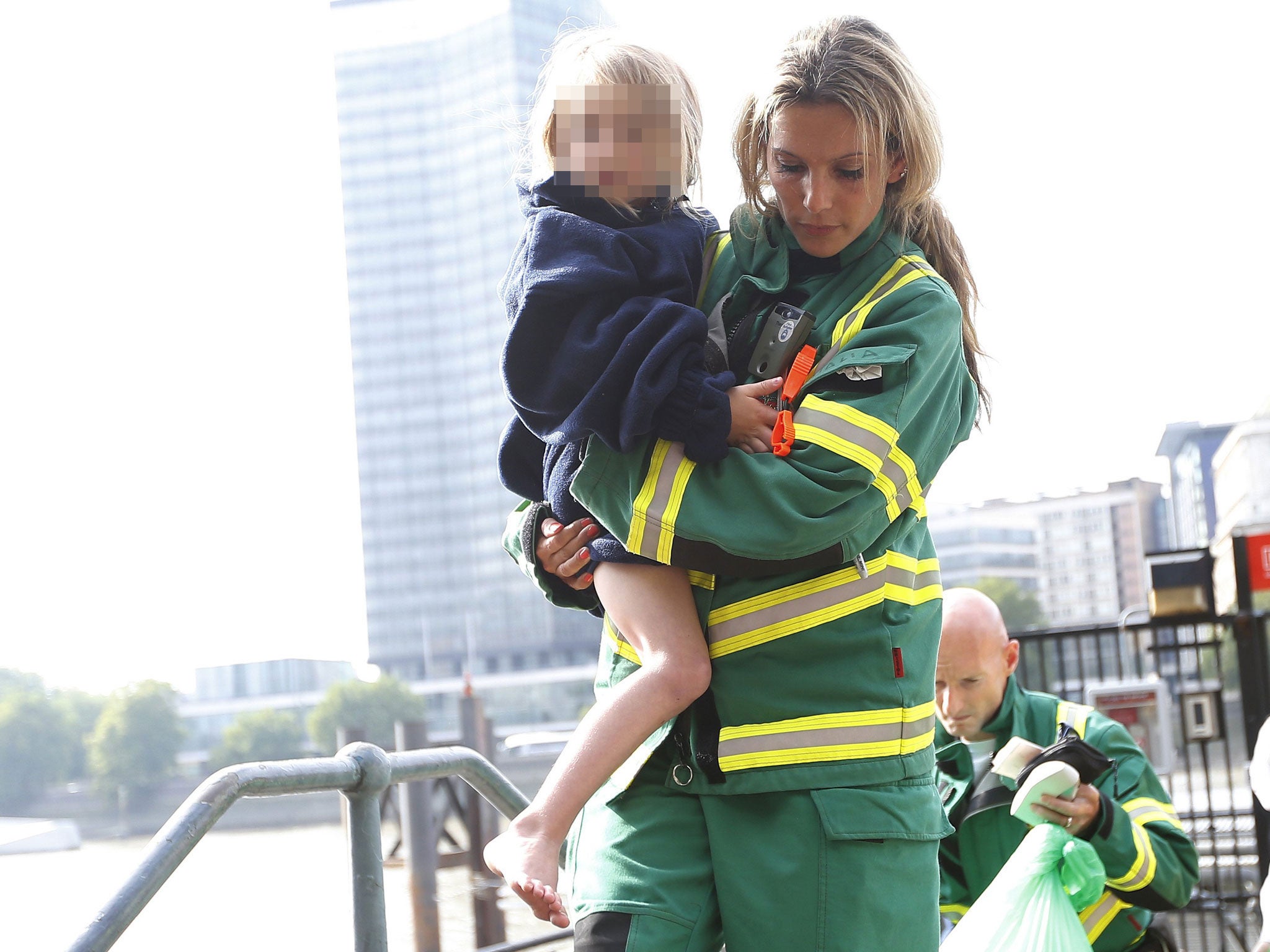 One of the fire service with a rescued child