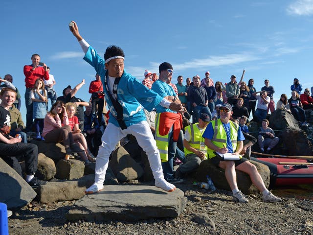 A Japanese competitor gets support from the crowd at the World Stone Skimming Championships on the Scottish island of Easdale
