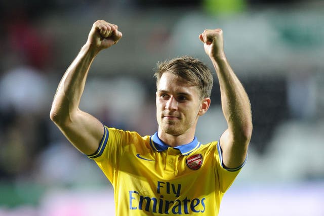 Aaron Ramsey raises his arms in triumph at the final whistle