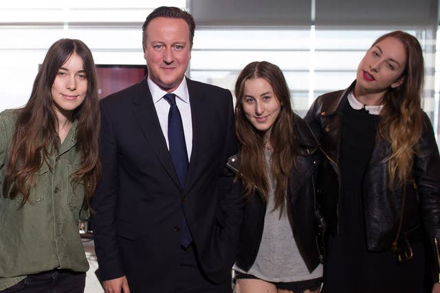 Prime Minister David Cameron poses the rock group Haim as they appear on the BBC current affairs programme, The Andrew Marr Show