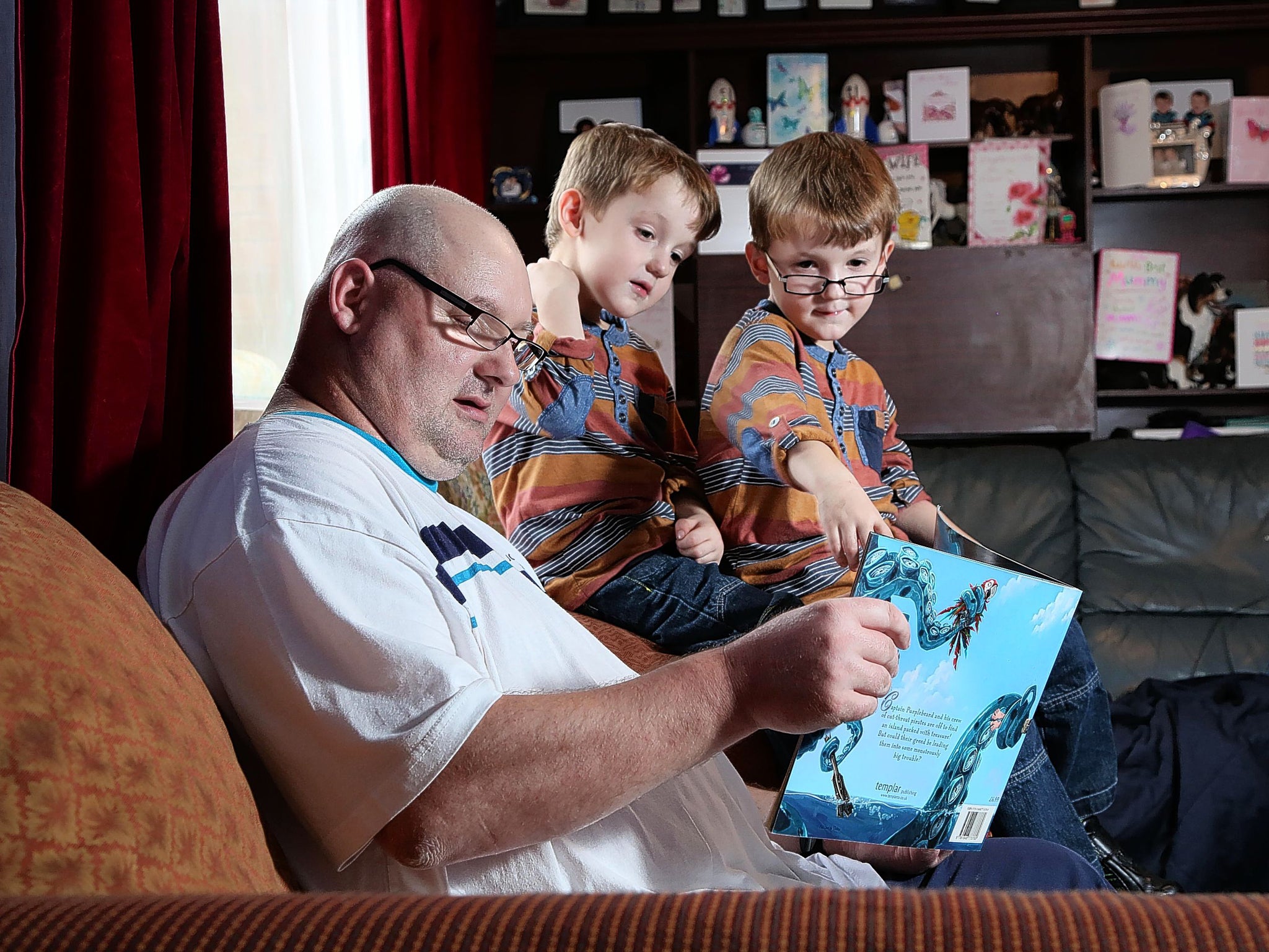 Ian Tibbetts reads to his twins Callum (left) and Ryan