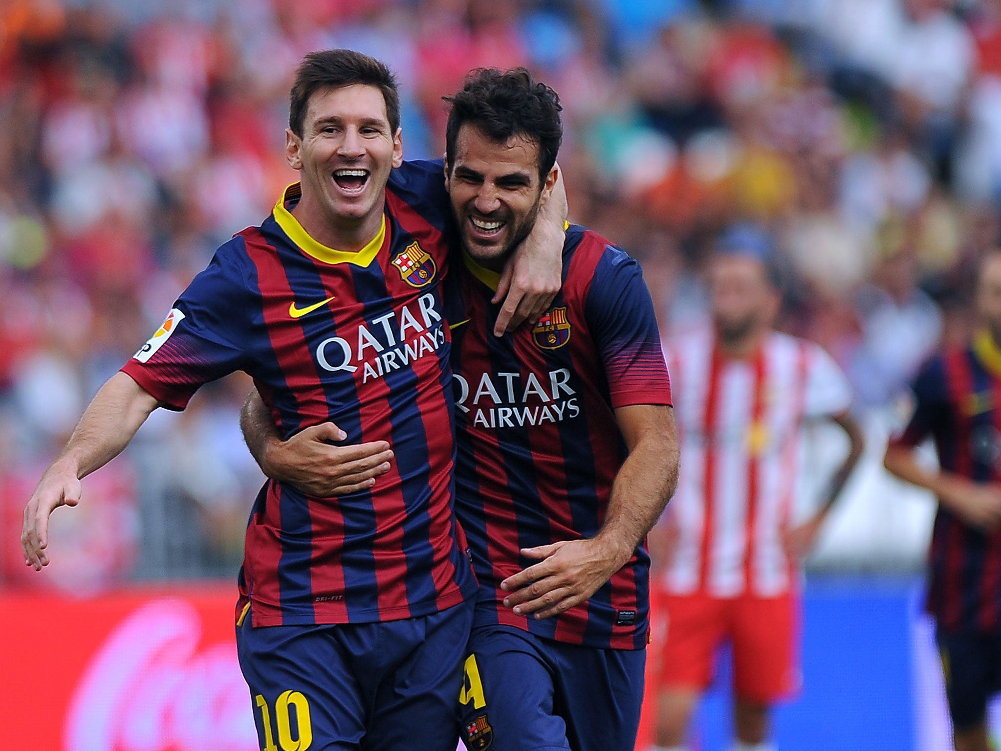 Lionel Messi celebrates alongside Cesc Fabregas after scoring for Barcelona against Almeria on the weekend