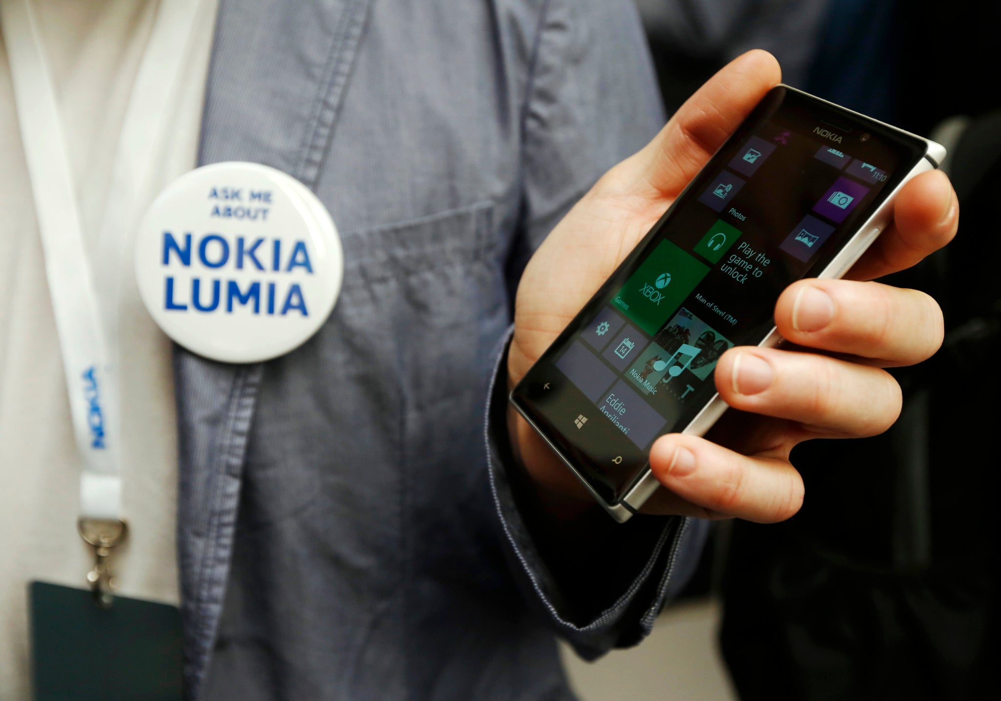 A worker poses with the new Nokia Lumia 925 at its launch.