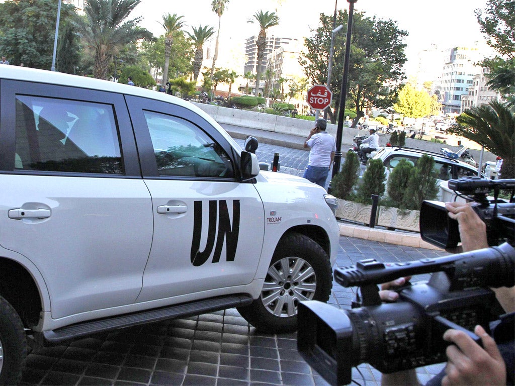 A UN vehicle transporting a team of weapons inspectors arrives at a hotel in Damascus