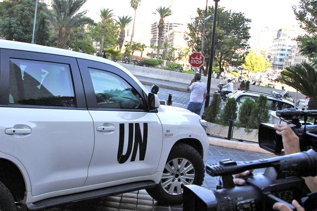 A UN vehicle transporting a team of weapons inspectors arrives at a hotel in Damascus