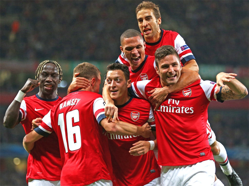 Mesut Ozil celebrates his first Arsenal goal