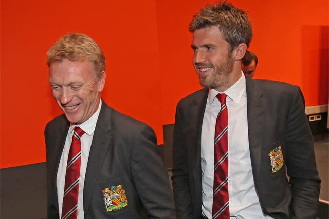 The United manager, David Moyes, arrives with midfielder Michael Carrick for his press conference in Donetsk
