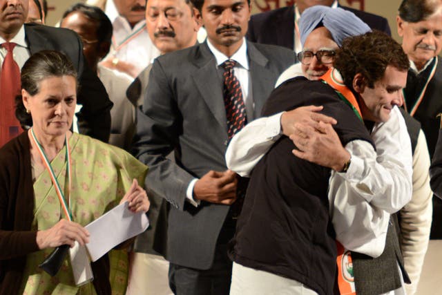 Rahul Gandhi hugs Indian Prime Minister Manmohan Singh, before delivering his first speech as Congress party Vice-President, while Gandhi's mother and Congress Party President Sonia Gandhi looks on.