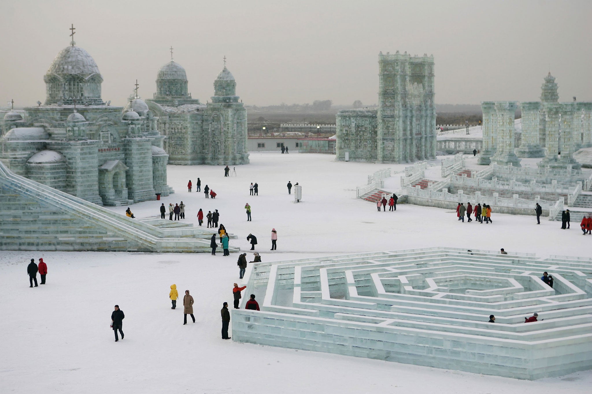 Tourists in one of China's coolest regions inspect buildings constructed out of blocks of ice