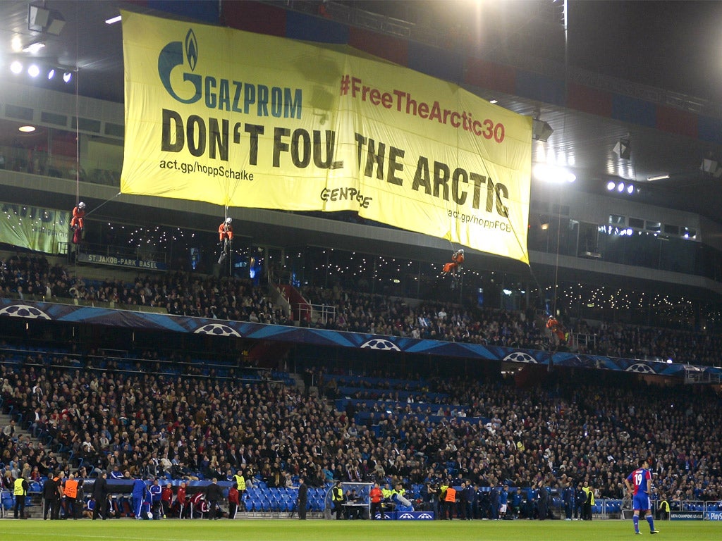 Greenpeace activists hold a demonstration during the Champions League match between Basel and Schalke