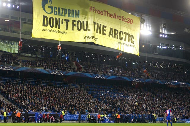 Greenpeace activists hold a demonstration during the Champions League match between Basel and Schalke