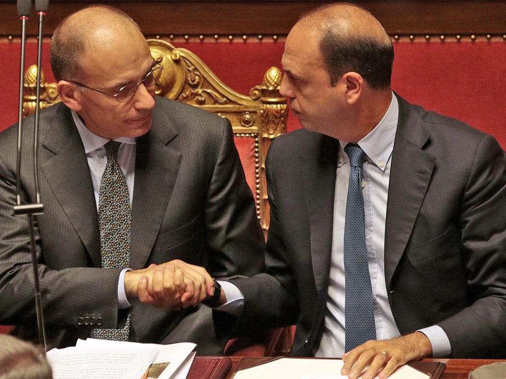 Prime Minister Enrico Letta (left) shakes hands with Interior Minister Angelino Alfano