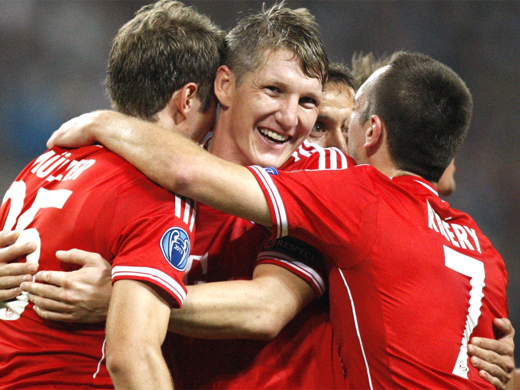 Thomas Mueller, Bastian Schweinsteiger and Franck Ribery celebrate a comfortable victory for Bayern