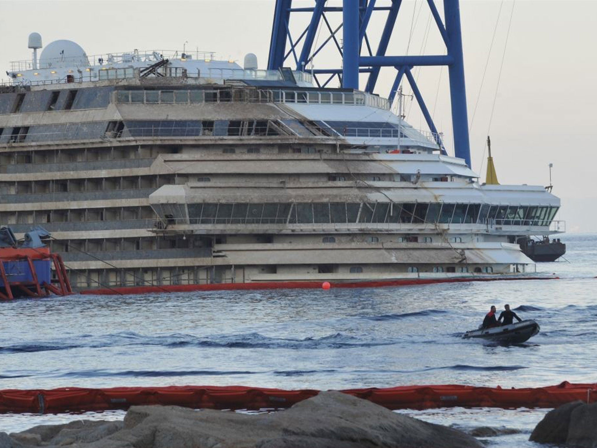 Carabinieri (national military police) bring ashore a box containing the remains of a person found during searches aboard the Costa Concordia ship