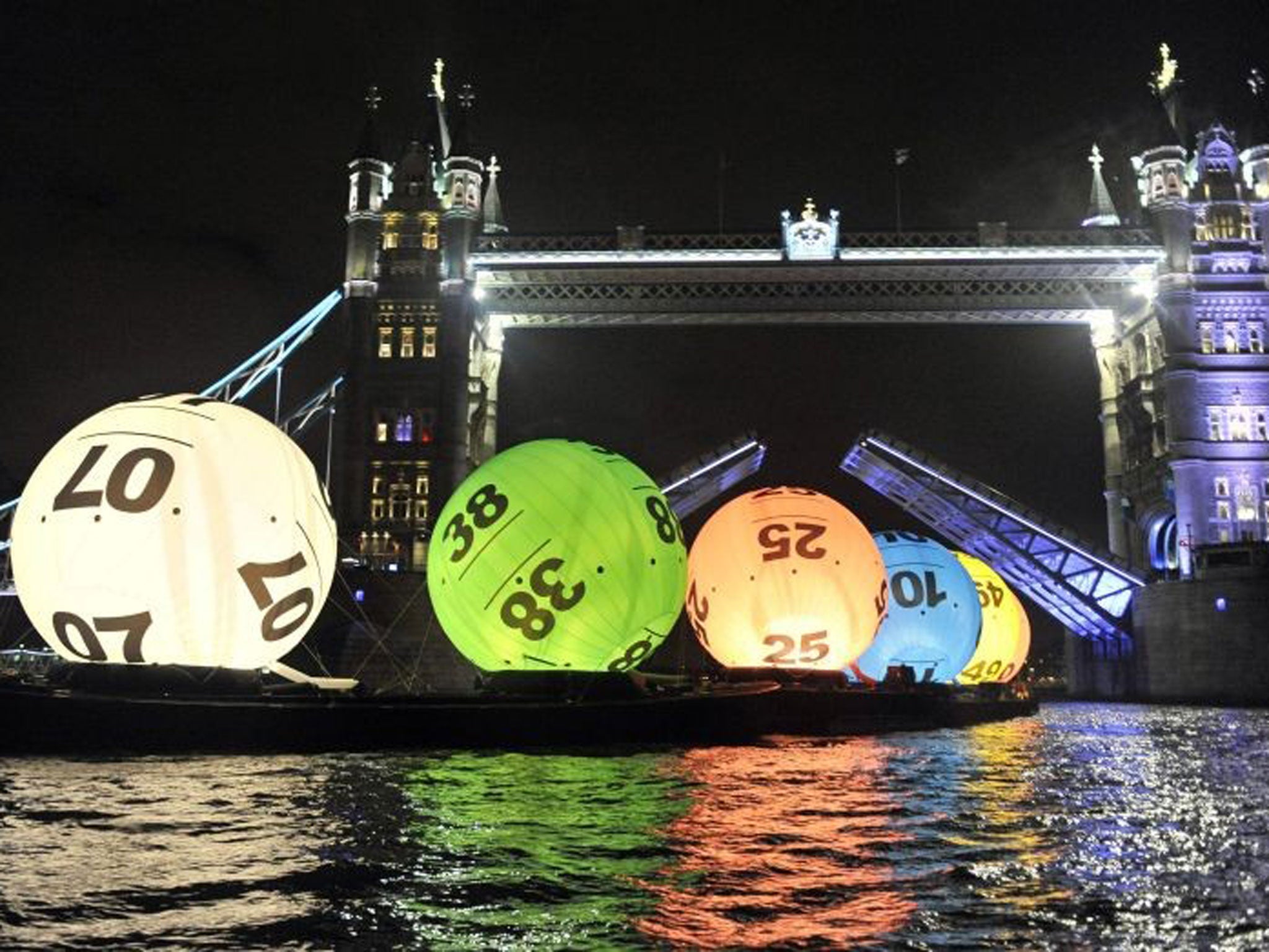 Camelot floats 26-ft Lotto balls down the Thames to celebrate new price system, with the cost of a ticket doubling
