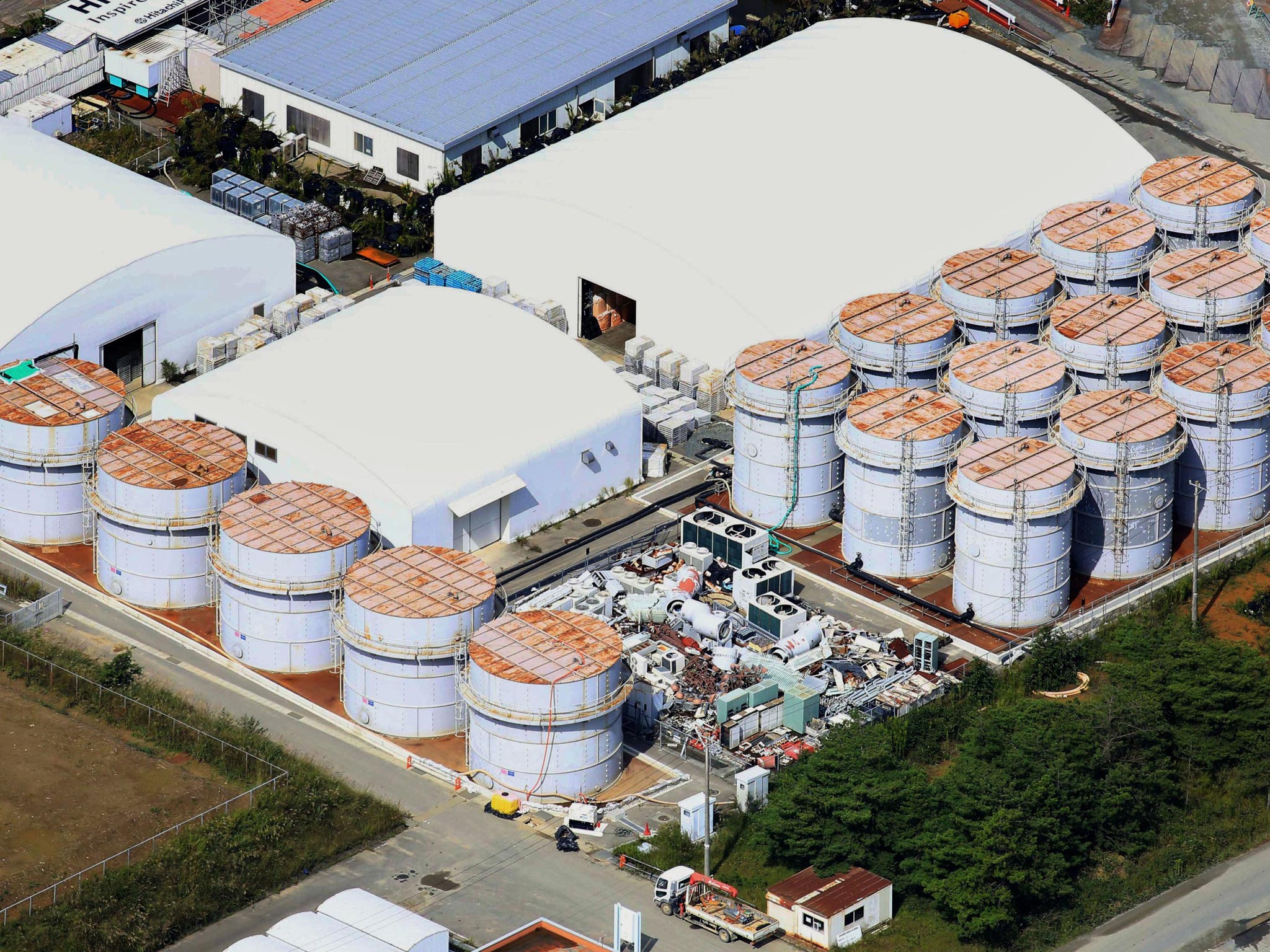 This aerial photo shows the storage tank, fifth from left at left plot, which workers detected the water dripping from the top, at the Fukushima Dai-ichi nuclear plant at Okuma town in Fukushima prefecture, northeastern Japan