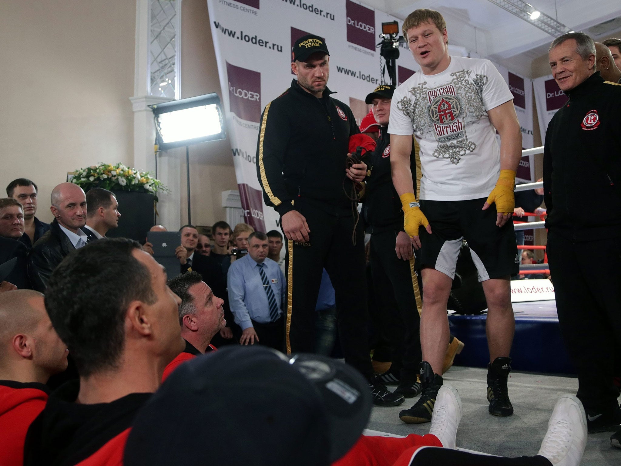 Alexander Povetkin (second right) has words with Vladimir Klitschko (bottom left) in the build-up to their world title fight