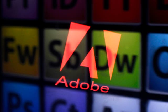 2013An Adobe logo and Adobe products are seen reflected on a monitor display and an iPad screen.