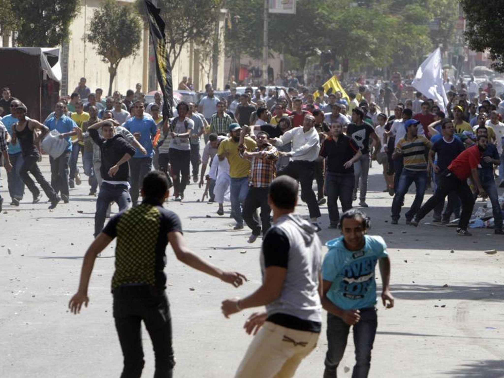 Supporters of deposed President Mohamed Morsi and the Muslim Brotherhood clash with anti-Morsi protesters during a march in Shubra street in Cairo