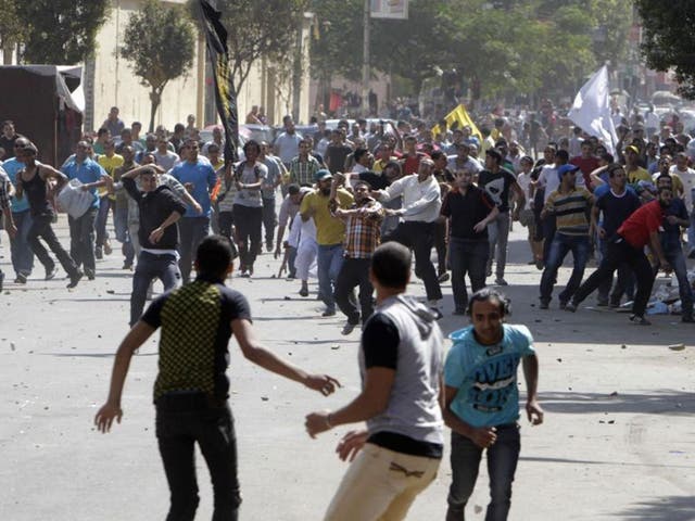 Supporters of deposed President Mohamed Morsi and the Muslim Brotherhood clash with anti-Morsi protesters during a march in Shubra street in Cairo