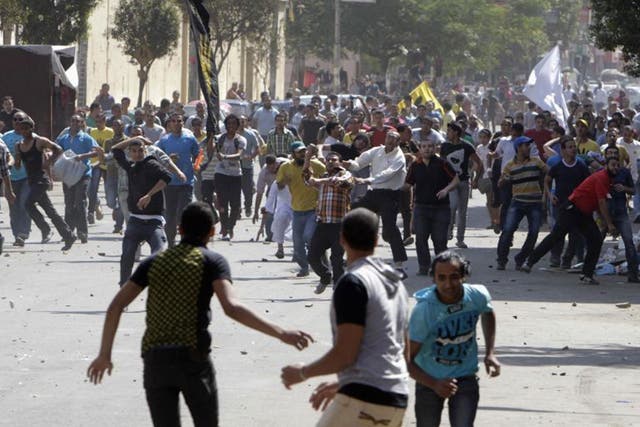Supporters of deposed President Mohamed Morsi and the Muslim Brotherhood clash with anti-Morsi protesters during a march in Shubra street in Cairo