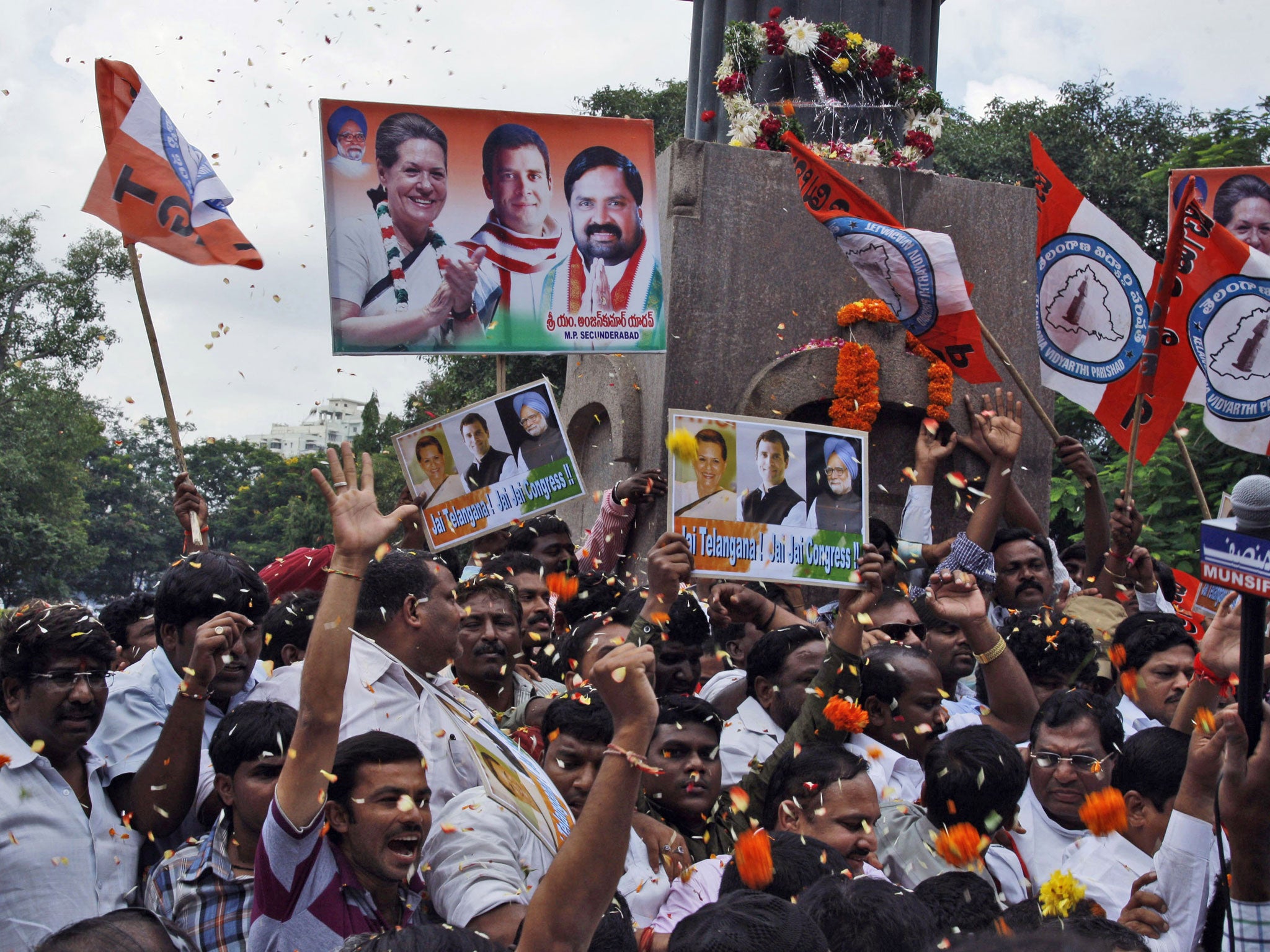 Indian Congress members and supporters celebrate after India’s Union Cabinet approved the creation of a new state