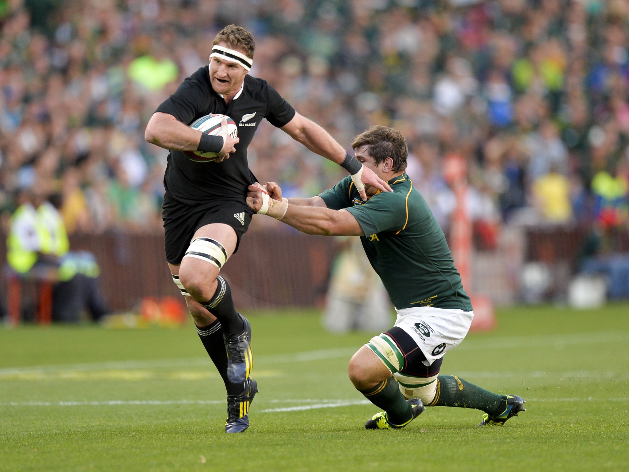 Kieran Read of New Zealand powers past Willem Alberts of South Africa