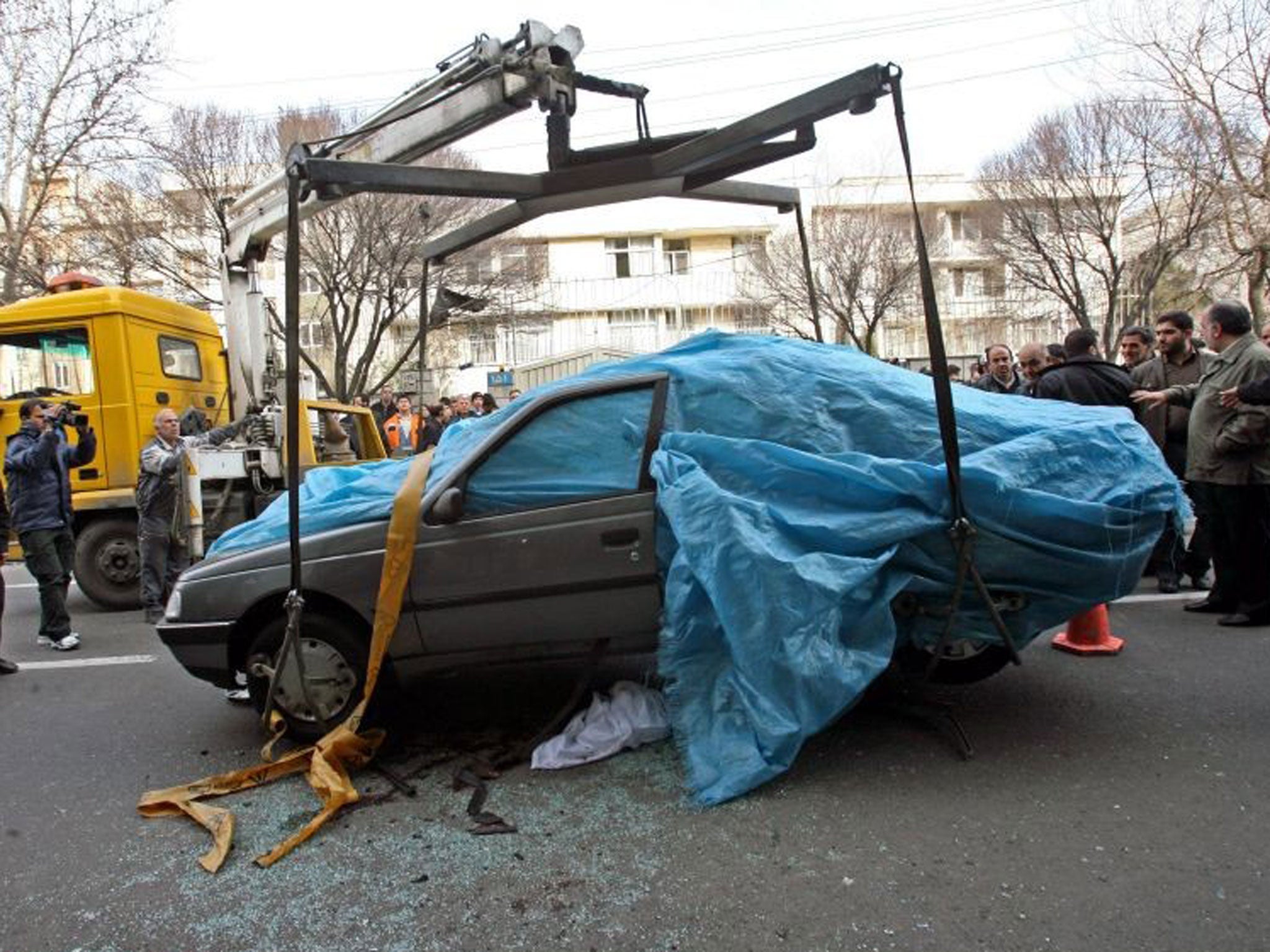 Grim toll: The bombed car of Mostafa Ahmadi-Roshan, who was killed in January 2012 – one of five to die since 2007