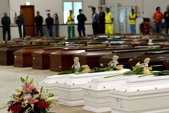 Coffins of children among the adult victims in a hangar of Lampedusa airport 